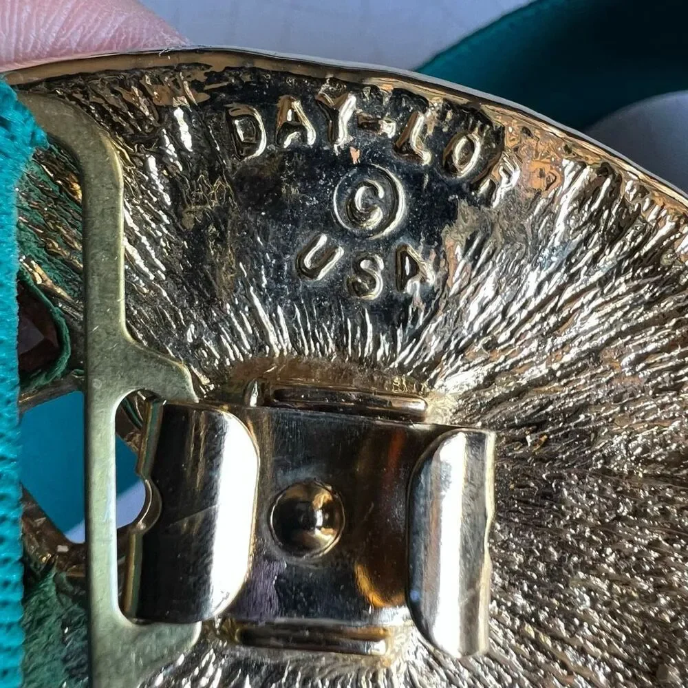 Day-lor usa Vintage elastic belt features a distinctive two-piece green enamel a